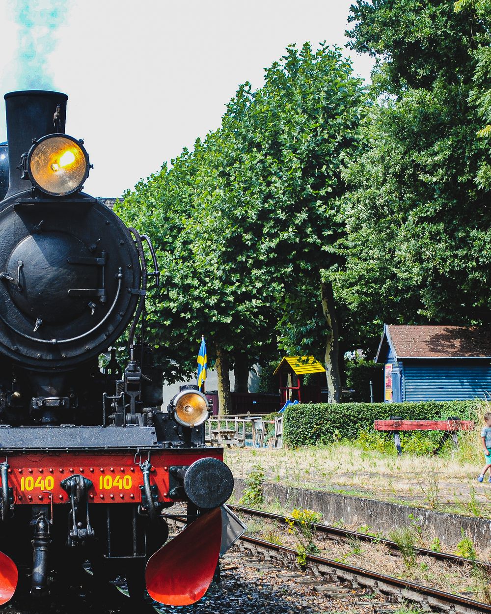 A vintage steam locomotive standing at a heritage railway platform